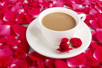 Red rose petals background and a cup of coffee. Morninig, spring, fashion composition. side view,