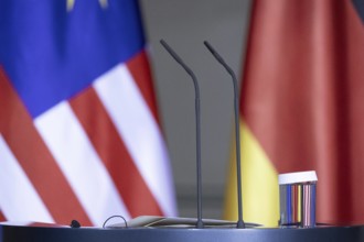 Microphone and flags taken during a press conference between Federal Chancellor Olaf Scholz and