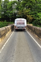 Eriba Touring caravan drives over single lane bridge, River Dee, cult, retro, Llangollen, Wrexham,