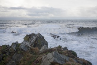 Large Atlantic storm waves crashing onto jagged rocky coast at Hartland Quay, north Devon, England,