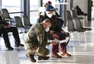 Vaccinees and a soldier of the German Armed Forces in the vaccination centre in Terminal 5 of BER