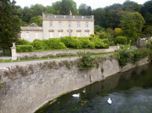 River Frome and the classical Georgian facade of Iford Manor, near Freshford, Wiltshire, England,