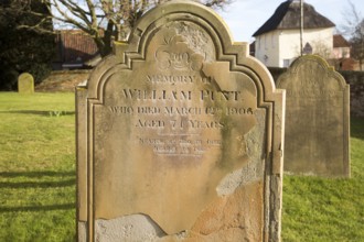 Headstones of graves in churchyard of Saint Peter church, village of Levington, Suffolk, England,