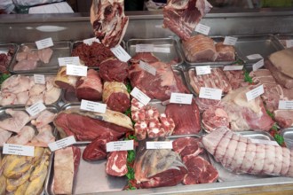 Cuts of meat in shop window of butcher shop, Green Street, Bath, Somerset, England, UK