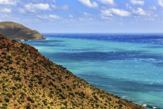 Mirador de La Amatista with view of rocky coast and turquoise sea, coastline at La Isleta, sunny