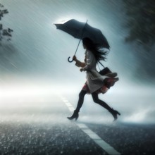 A young woman walks with an umbrella through a thunderstorm with rain and storm, symbol image