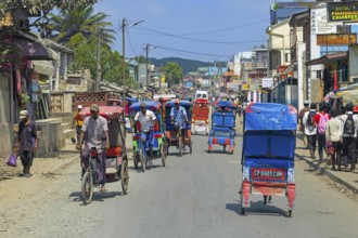 Cycle rickshaws, cyclo-pousses, velotaxis in bust street in the city Moramanga, Alaotra-Mangoro