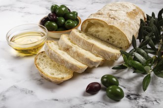 Appetizer, sliced ciabatta bread, with olive oil, green olives, Chalkidiki olives, classic Green