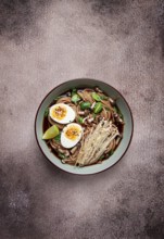 Soba, buckwheat noodles, with enoki mushrooms, shimeji and boiled egg, top view, homemade, no