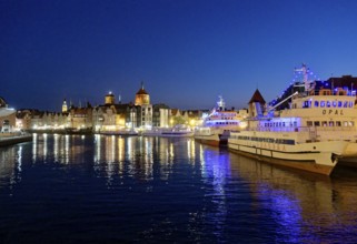 The harbour in the city centre of Gdansk illuminated in the evening. Gdansk, Pomerania, Poland,