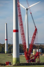 Assembly of a wind turbine, the last rotor blade is being mounted, mobile crane, wind turbine from