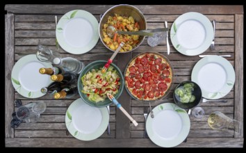 Garden table set with salads and a quiche, Bavaria, Germany, Europe