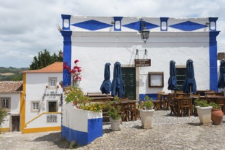 Outdoor area of a restaurant with blue accents under a sunny sky, Óbidos, Obidos, Oeste, Centro,