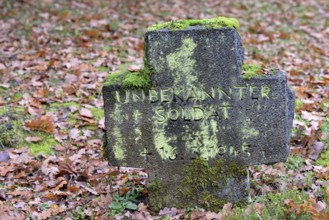 Military cemetery from the Second World War, moss-covered stone cross with inscription, Moselle,