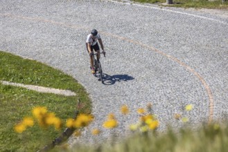 Cyclists on the road on La Tremola, the world-famous Alpine pass through the Val Tremolo,