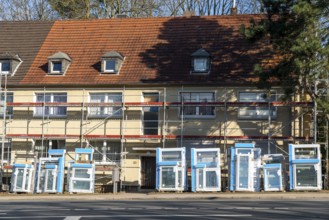 Energy-efficient refurbishment of residential buildings, older apartment block is scaffolded, gets