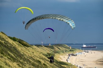 Paragliders along the dunes of Zoutelande, in Zeeland, South Holland, Netherlands