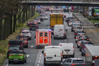 Rescue lane, ambulance making its way through city centre traffic with blue lights and siren,