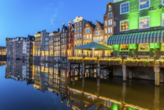 Canal houses on the Damrak, in the centre of the old town of Amsterdam, harbour, starting point of