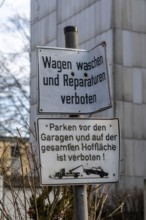 Garage courtyard of a residential building, signs indicating the ban on washing and repairing cars,