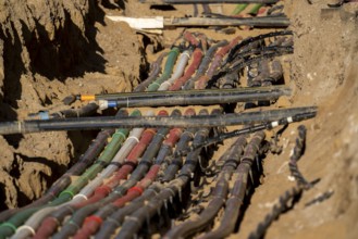 Cables, pipes, next to each other in a construction site, supply lines exposed during construction