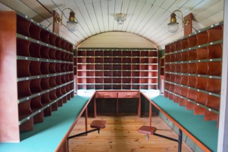 Interior view of a mail coach with wooden shelves and desks, mail coach, railway museum, Elk, Elk,