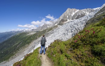 Mountaineer on the hiking trail La Jonction, mountain landscape with glacier Glacier des Bossons