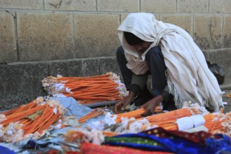 Europia district, Debre Lebanon, Lipanus monastery, man sorting wax torches for the pilgrims at the