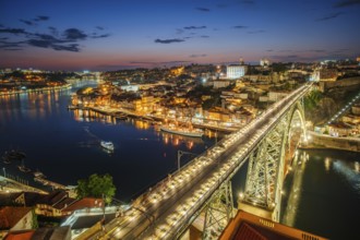 View of illuminated Porto city and Douro river and Dom Luis bridge I from famous tourist viewpoint