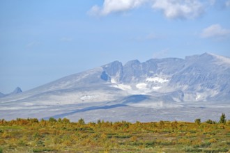 Snow-capped mountains and autumn landscape under a clear sky with clouds, autumn, Hjerkinn,