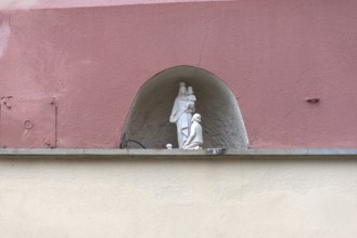 Small figures of saints in a niche on a residential building in the historic centre, Genoa, Italy,