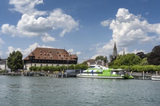 View over the harbour basin of Constance with the catamaran, the council building on the lakeside