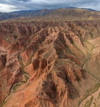 Eroded mountain landscape, canyon with red and orange rock formations, aerial view, Konorchek