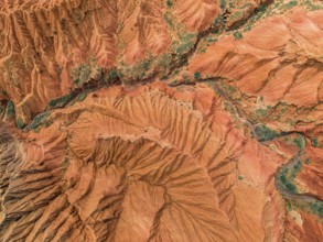 Eroded mountain landscape, top-down, canyon with red and orange rock formations, aerial view,