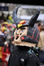 Person masked as a devil at the carnival parade of the Wey guild on Rose Monday, Güdismäntig,