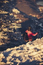 A woman's ski tour at sunrise on the Tegelberg in the Allgäu in the Ammergebirge, Bavaria, Germany,