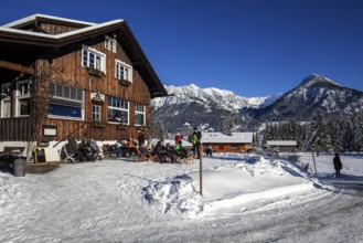 Winter landscape in the snow, Cafe Restaurant Kratsbichl, behind mountains of the Allgäu Alps,