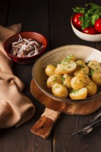 Fresh Cooked, new potatoes, with dill, on a wooden table, selective focus. close-up, toning, no