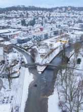 Snowy town with a river flowing through the buildings and spanned by a bridge, Nagold, Black