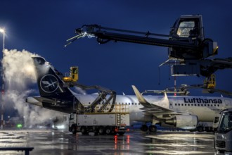 Winter at Frankfurt Main Airport, FRA, Lufthansa aircraft being de-iced by de-icing vehicles,