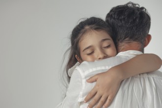 Female child hugging her father. Broken up white chocolate bars, AI generated