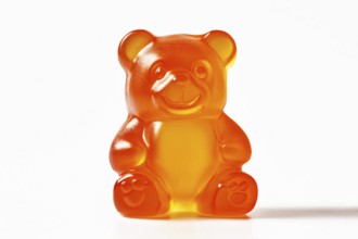 Cute orange jelly bear fruit gum candy on white background. Generative Ai, AI generated