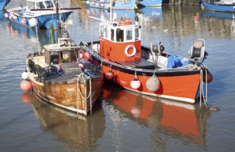 Fishing boats in the harbour at West Bay, Bridport, Dorset, England, UK