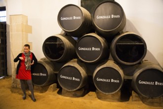 Female guide explaining fino sherry production wine cellar, Gonzalez Byass bodega, Jerez de la