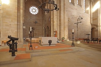 Interior view with chancel of the Romanesque abbey church, altar, candlestick, book stand,