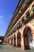 Historic buildings in Plaza de Corredera seventeenth century colonnaded square, Cordoba, Spain,