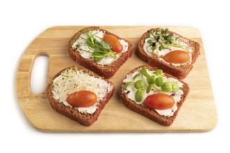 Red beet bread sandwiches with cream cheese, tomatoes and microgreen isolated on white background.