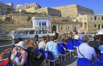 People onboard ferry boat crossing harbour from Sliema to Valletta, Malta, Europe