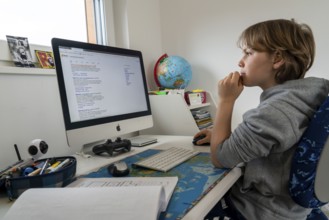 Young, primary school pupils, home learning, doing schoolwork, distance learning, virtual