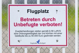 Sign on an airport barrier fence, trespassing by unauthorised persons prohibited, Stuttgart,